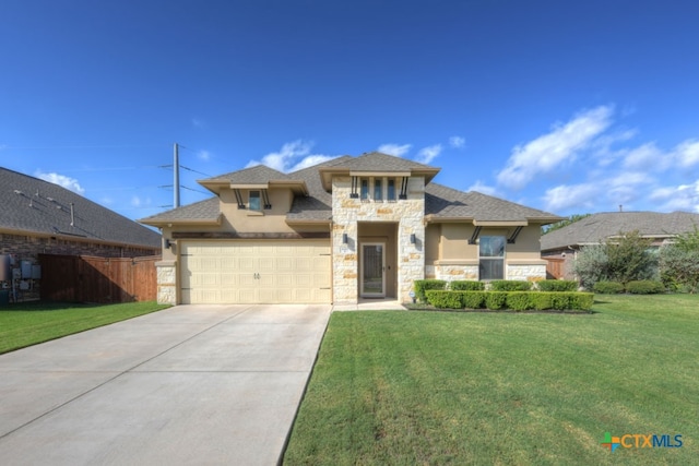 view of front facade with a garage and a front lawn