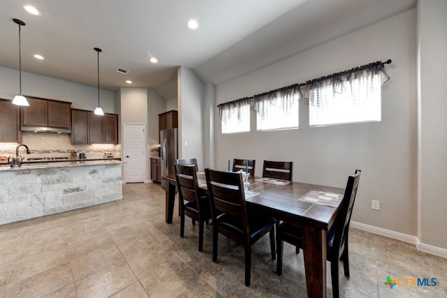 dining space with lofted ceiling