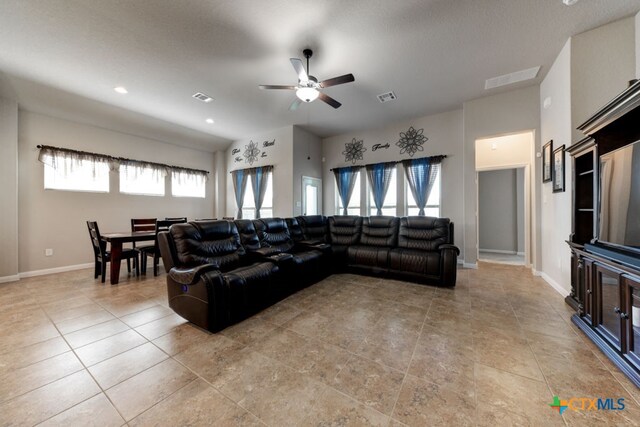 living room featuring ceiling fan and plenty of natural light