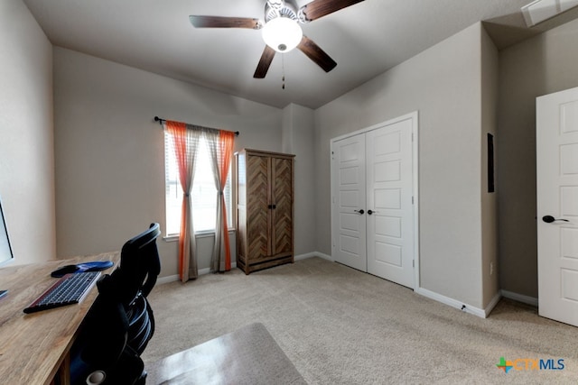 carpeted office space featuring ceiling fan