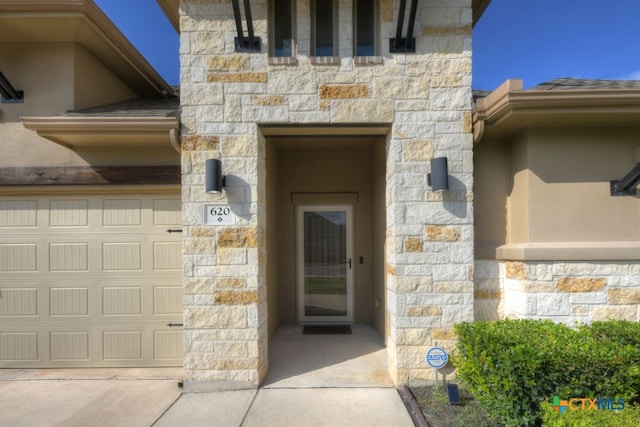 entrance to property featuring a garage