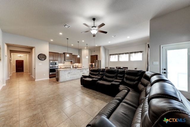 living room featuring ceiling fan and light tile patterned floors