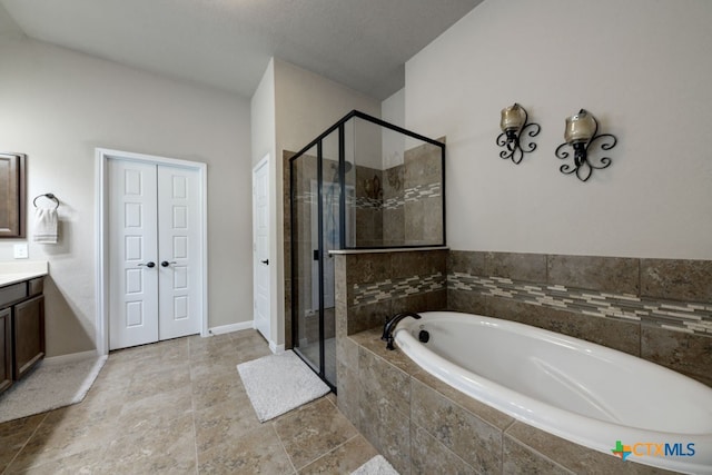 bathroom with independent shower and bath and vanity