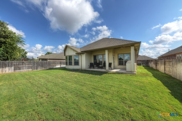 back of property with a patio and a yard