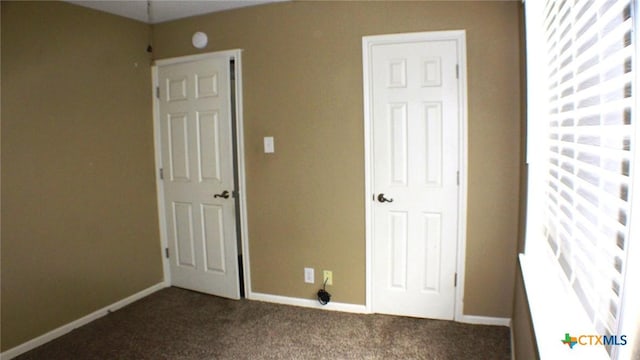 4601 Evergreen Ln, Victoria, TX 77904 - unfurnished bedroom with dark colored carpet and baseboards