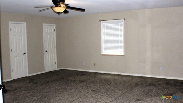 carpeted spare room with ceiling fan