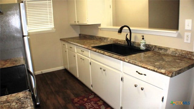 4601 Evergreen Ln, Victoria, TX 77904 - kitchen featuring dark wood-type flooring, stove, white cabinets, and dark countertops