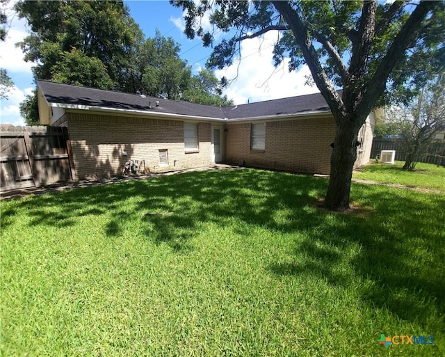 back of house with a lawn