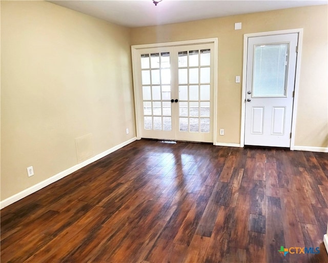 unfurnished room featuring french doors and dark wood-type flooring