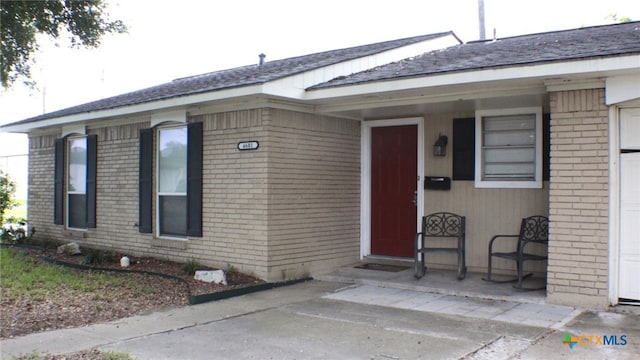 view of exterior entry with a porch