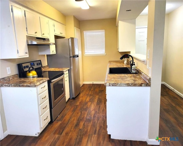 4601 Evergreen Ln, Victoria, TX 77904 - kitchen with stainless steel appliances, under cabinet range hood, dark wood-type flooring, and white cabinets