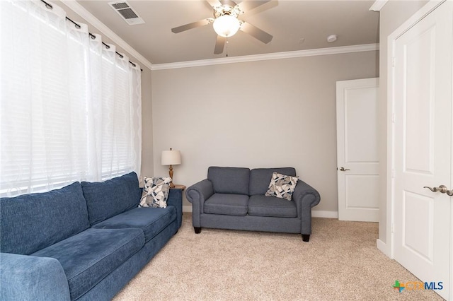 living room with light carpet, a wealth of natural light, ceiling fan, and ornamental molding