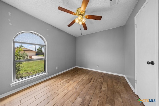 101 E Hogan Dr, Copperas Cove, TX 76522 - empty room with a textured ceiling, wood finished floors, and ceiling fan