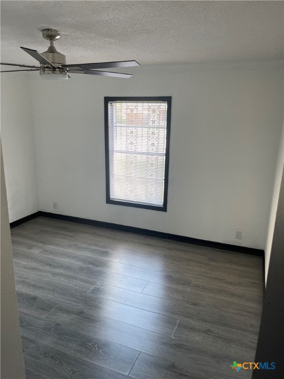 unfurnished room featuring ceiling fan, dark hardwood / wood-style floors, and a textured ceiling