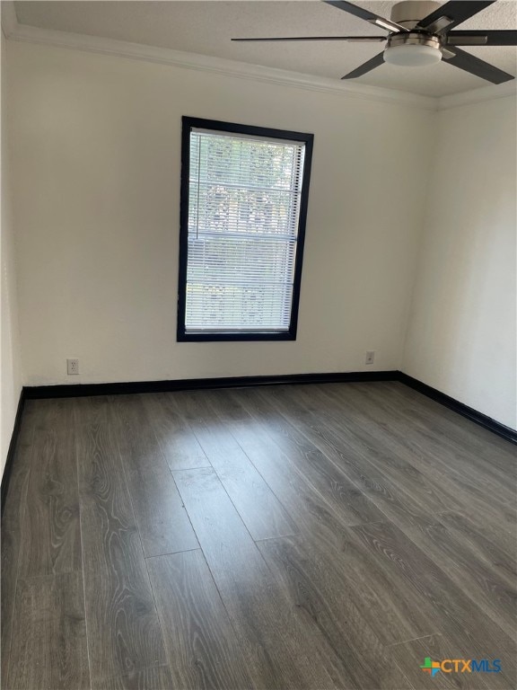 unfurnished room featuring dark wood-type flooring, ceiling fan, and crown molding