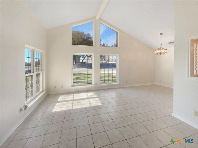 unfurnished room featuring light tile patterned floors, beamed ceiling, a wealth of natural light, and a chandelier