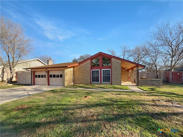 mid-century home with concrete driveway, fence, brick siding, and a front lawn