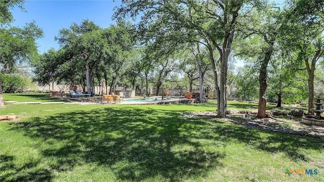 680 Saddleridge Dr, Wimberley, TX 78676 - view of community with fence, a yard, and a pool