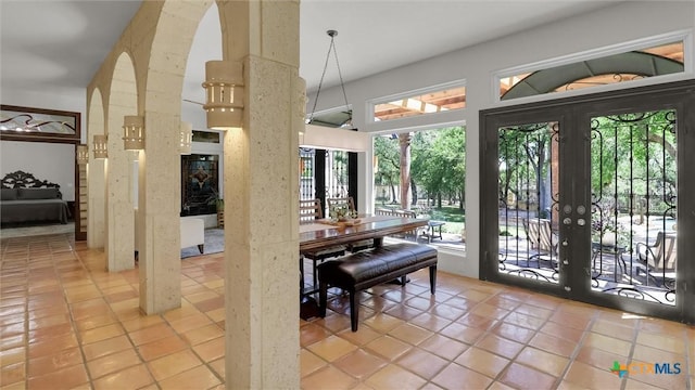 680 Saddleridge Dr, Wimberley, TX 78676 - dining space featuring arched walkways, a healthy amount of sunlight, and french doors