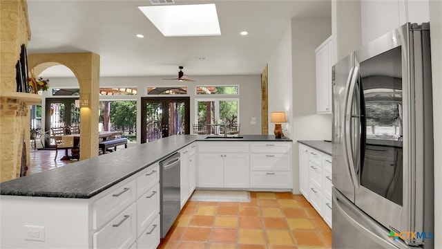 680 Saddleridge Dr, Wimberley, TX 78676 - kitchen with recessed lighting, stainless steel appliances, a peninsula, and white cabinetry