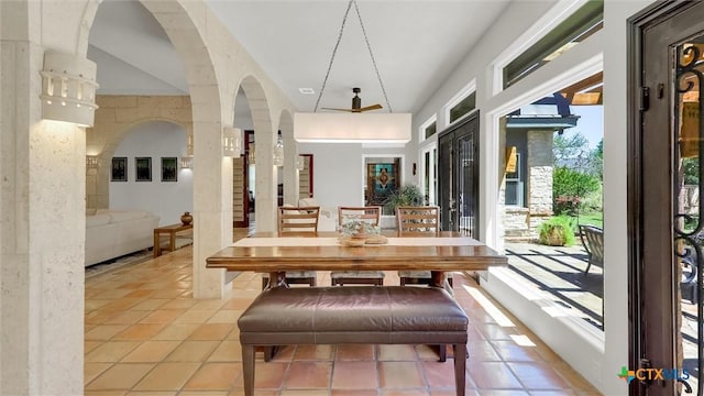 680 Saddleridge Dr, Wimberley, TX 78676 - dining space with light tile patterned floors and arched walkways