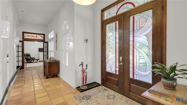 680 Saddleridge Dr, Wimberley, TX 78676 - foyer featuring french doors, light tile patterned flooring, and visible vents