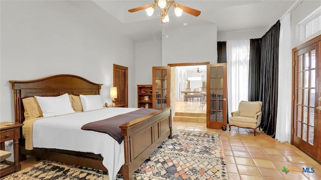 680 Saddleridge Dr, Wimberley, TX 78676 - bedroom with french doors, ceiling fan, and light tile patterned floors