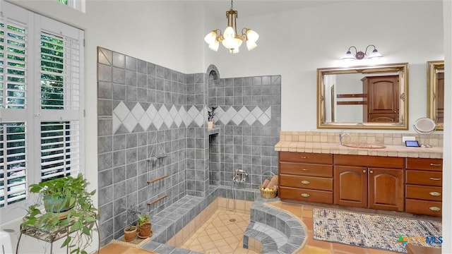680 Saddleridge Dr, Wimberley, TX 78676 - bathroom with a walk in shower, a chandelier, tasteful backsplash, and vanity
