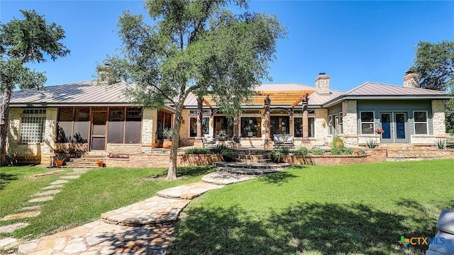 680 Saddleridge Dr, Wimberley, TX 78676 - back of house featuring french doors, a chimney, a standing seam roof, metal roof, and a lawn