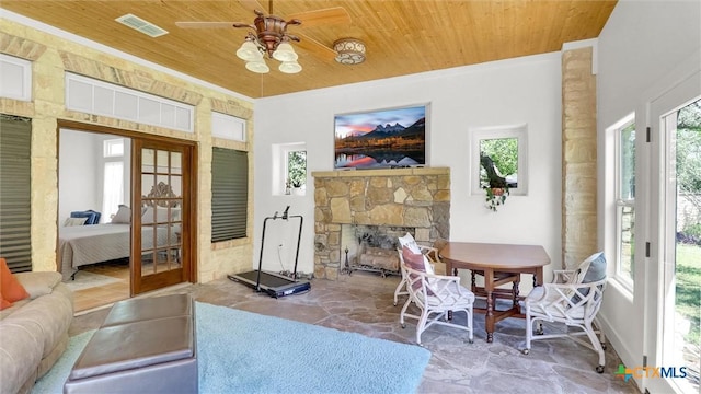 680 Saddleridge Dr, Wimberley, TX 78676 - living area with stone floors, visible vents, wooden ceiling, and plenty of natural light