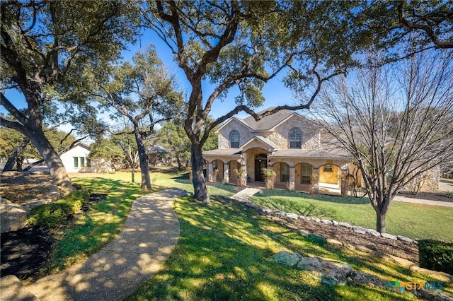 view of front of property featuring a front lawn and covered porch