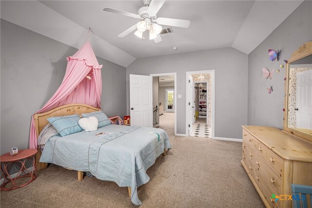 carpeted bedroom featuring lofted ceiling, a spacious closet, and ceiling fan