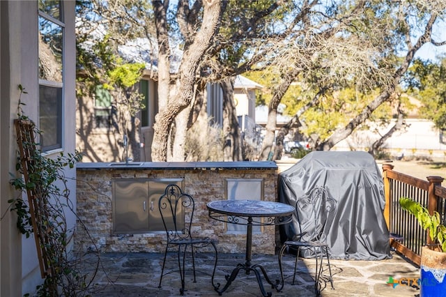 view of patio with a grill and an outdoor bar