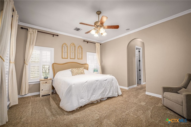 carpeted bedroom with ornamental molding and ceiling fan