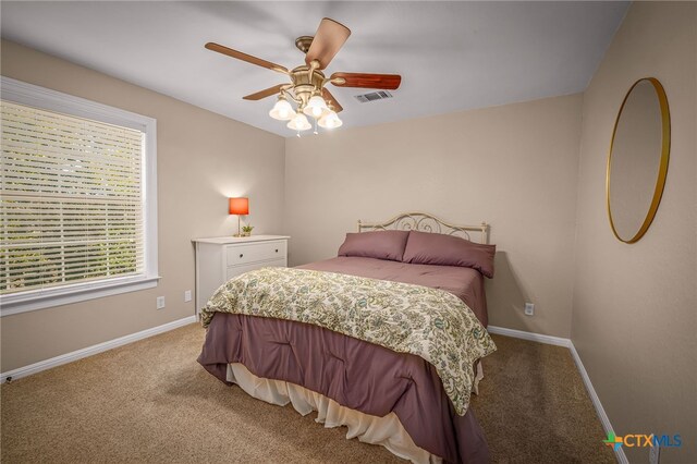 bedroom featuring ceiling fan and light carpet