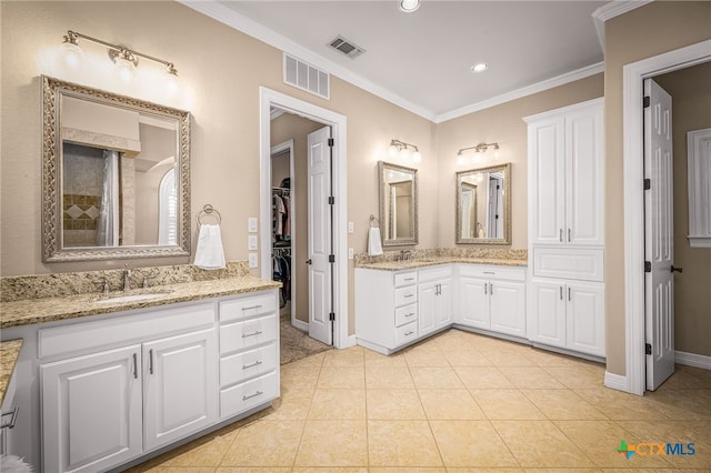 bathroom featuring crown molding, tile patterned floors, and vanity