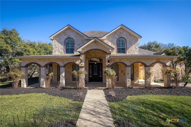 view of front of home with a porch and a front yard