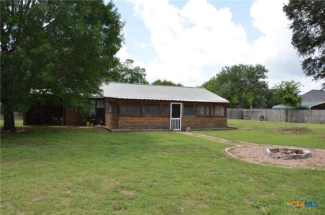 210 Meadow Ln, Martindale, TX 78655 - rear view of house with a fire pit and brick siding