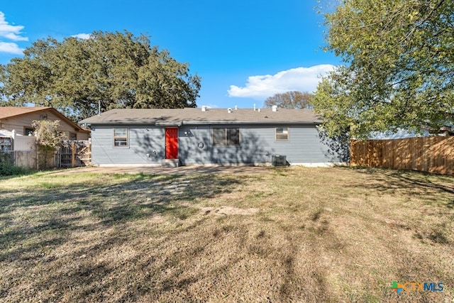 rear view of property with a yard