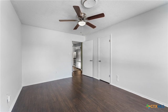 unfurnished bedroom featuring dark hardwood / wood-style floors, ceiling fan, a textured ceiling, and stainless steel refrigerator