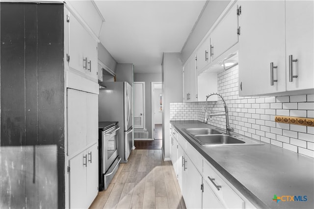 kitchen with light hardwood / wood-style floors, white cabinetry, backsplash, and electric stove