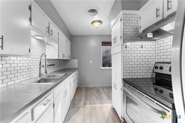 kitchen featuring white cabinets, light wood-type flooring, sink, and appliances with stainless steel finishes