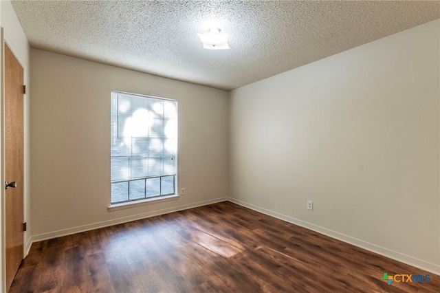 202 Liberty St, Gatesville, TX 76528 - empty room featuring dark wood finished floors, baseboards, and a textured ceiling