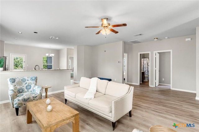 480 Waterloo Dr, Kyle, TX 78640 - living area with a ceiling fan, baseboards, light wood finished floors, a chandelier, and recessed lighting