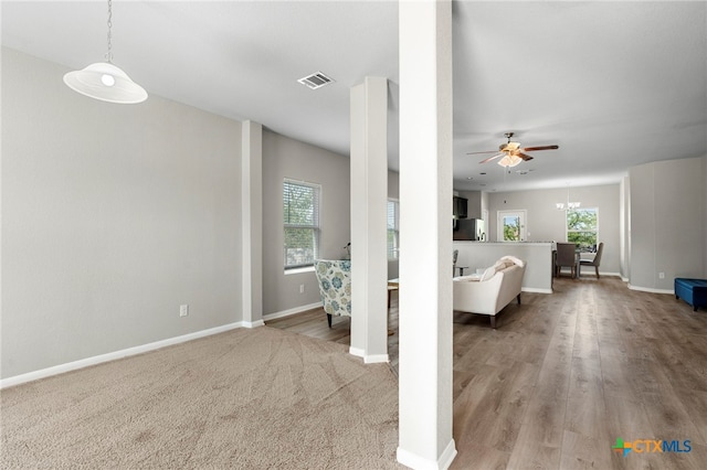 480 Waterloo Dr, Kyle, TX 78640 - living area featuring baseboards, a ceiling fan, a chandelier, and wood finished floors