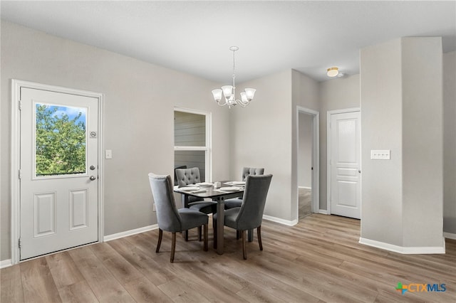 480 Waterloo Dr, Kyle, TX 78640 - dining room with a chandelier, light wood-type flooring, and baseboards