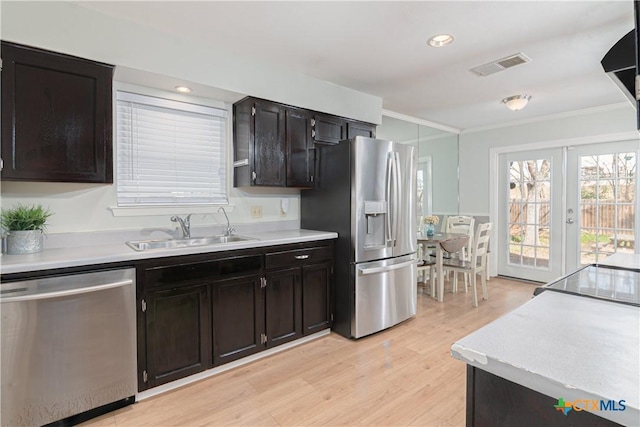 kitchen with stainless steel appliances, light countertops, visible vents, and a sink