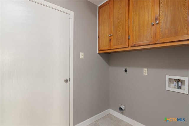 clothes washing area with cabinet space, hookup for a washing machine, baseboards, and electric dryer hookup