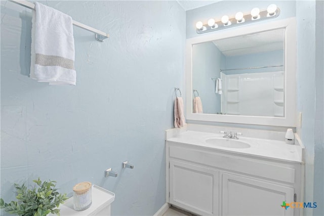 bathroom with a shower and vanity