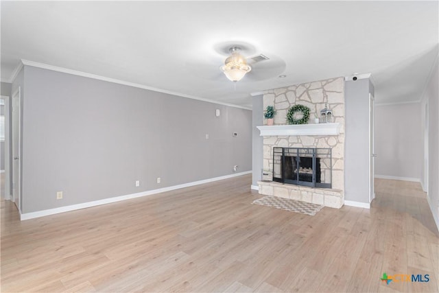 unfurnished living room featuring ornamental molding, a fireplace, visible vents, and light wood-style floors